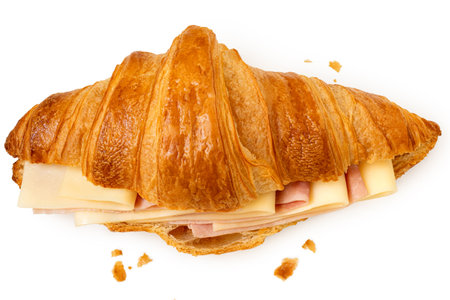 Ham and cheese croissant isolated on white. Crumbs.Top view.の写真素材