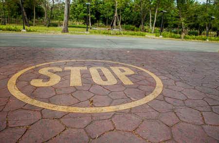 yellow stop sign painted on floorの写真素材