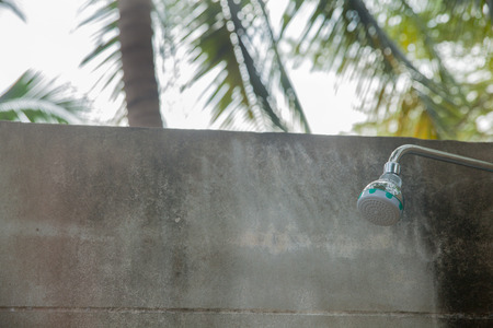 refreshing shower outdoor under treesの写真素材