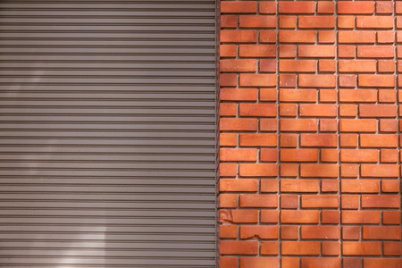 Red brick and metal door of the building