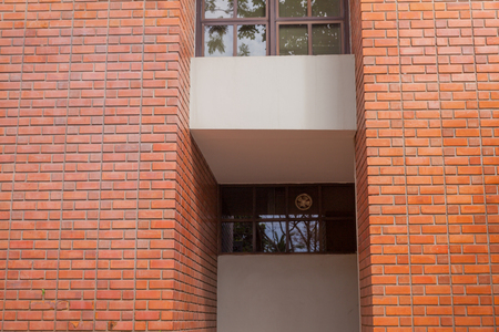 Red brick and metal door of the buildingの写真素材