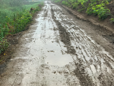 Road wet muddy of backcountry countrysideの写真素材
