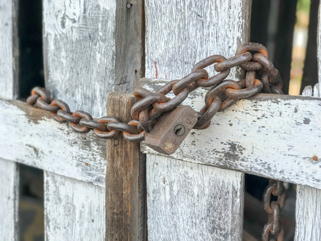 old outdoor Chain lock with wood fence
