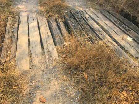 dirty Old wooden bridge cross the roadの写真素材
