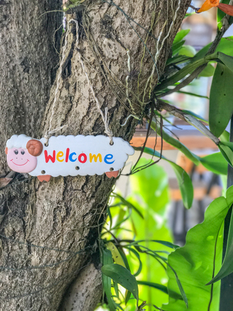 Welcom sign hang on tree at the hotelの写真素材
