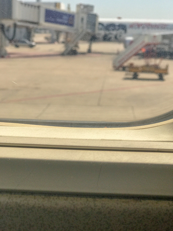 airport as seen through window of an aircraftの写真素材