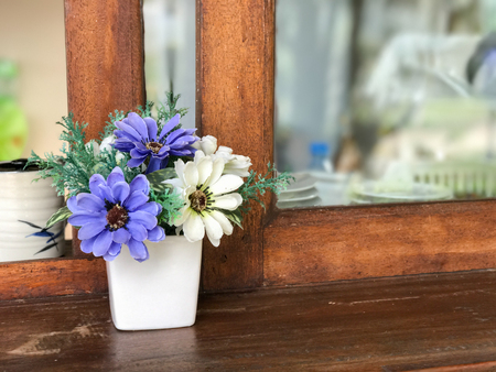 plastic Flower in the pot at the windowの写真素材