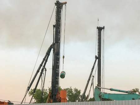 Diesel pile driver outside construction siteの写真素材