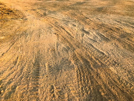 Wheel tracks dirt on country road in thailandの写真素材