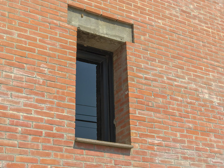 metal window and red brick wall at thailandの写真素材
