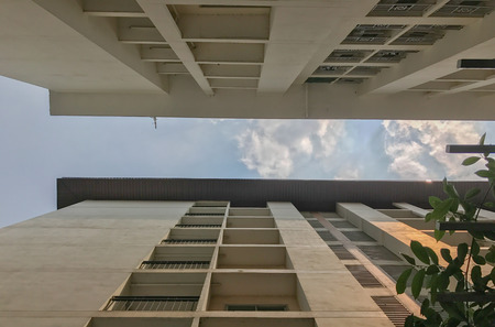 windows apartment building from below at thailandの写真素材