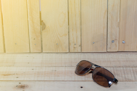 close up sun glasses on wooden board plankの写真素材