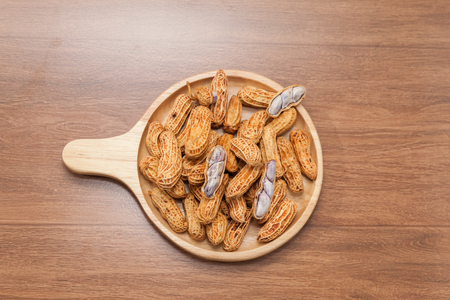 close up of boiled peanuts on wooden plateの写真素材