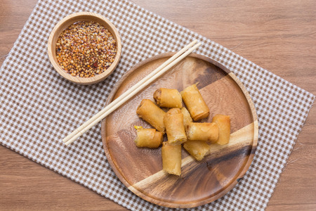 Fried Spring Roll on wooden plate with sauce