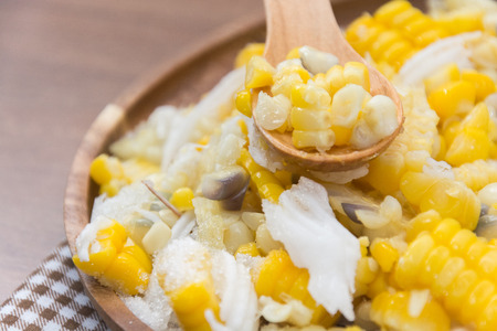 Sweet Corn with coconut and sugar on wooden plateの写真素材