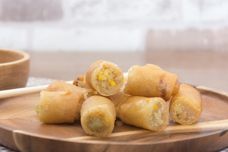 Fried Spring Roll on wooden plate with sauceの写真素材