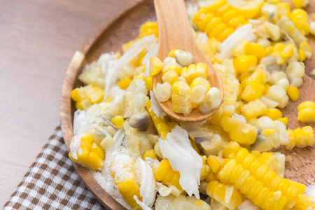 Sweet Corn with coconut and sugar on wooden plateの写真素材