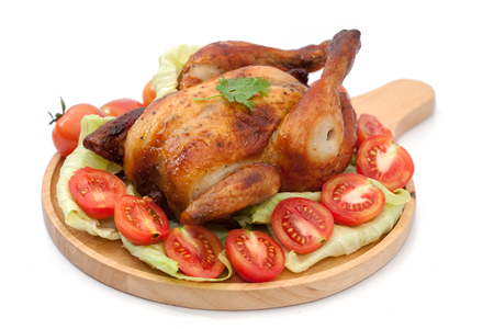 roast chicken on wooden plate  isolated on whiteの写真素材