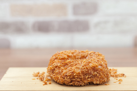 close up of Toasted Coconut doughnut on wooden plateの写真素材