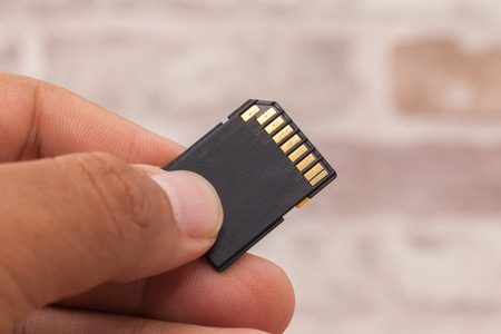 hand holding old memory card, Concept of data storageの写真素材