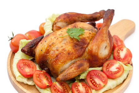 roast chicken on wooden plate  isolated on whiteの写真素材