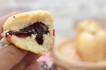 a variety of doughnut on wooden plate with sprinklesの写真素材