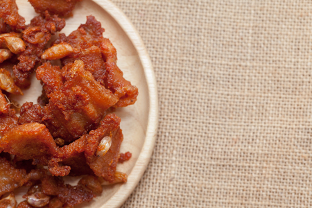 Fried Pork with Garlic Pepper on wooden plateの写真素材