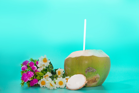 coconut with drinking straw, notebook and sunglasses on blue backgroundの写真素材