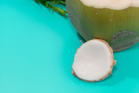 coconut with drinking straw, notebook and sunglasses on blue backgroundの写真素材