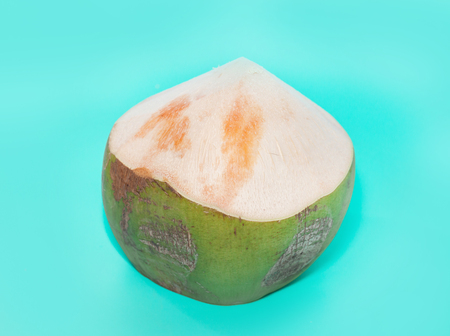 coconut with drinking straw, notebook and sunglasses on blue backgroundの写真素材