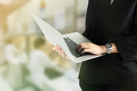 businessman use laptop on laboratory backgroundの写真素材
