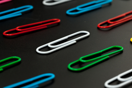 row of paper clip on black background, different conceptの写真素材