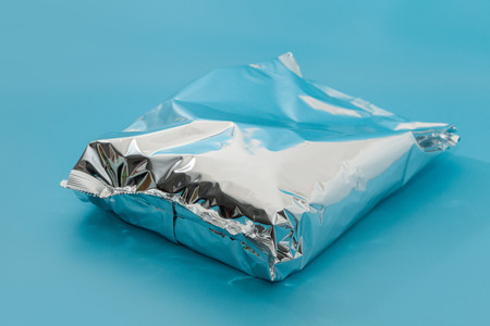 close up of snack foil bag on blue backgroundの写真素材
