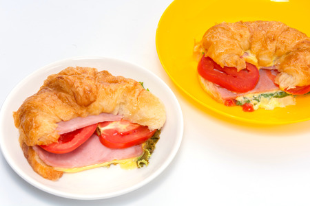 croissant ham and cheese on white plateの写真素材