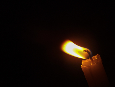 close up of candle light on black gackgroundの写真素材
