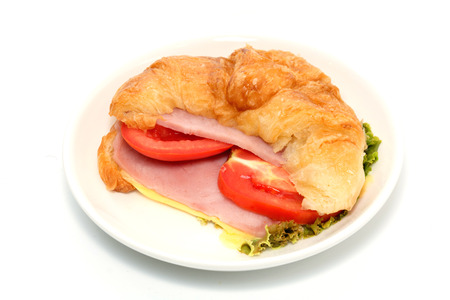 croissant ham and cheese on white plateの写真素材