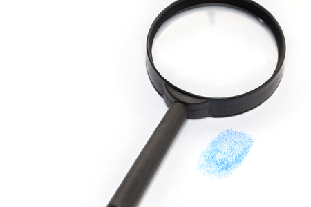 hand in blue glove and magnifying glassの写真素材