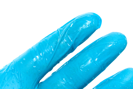 close up of hand in blue glove with waterの写真素材