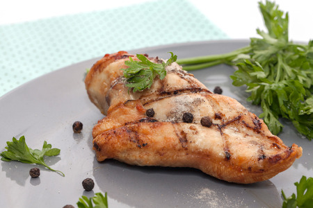 close up of grilled chicken breast on plateの写真素材