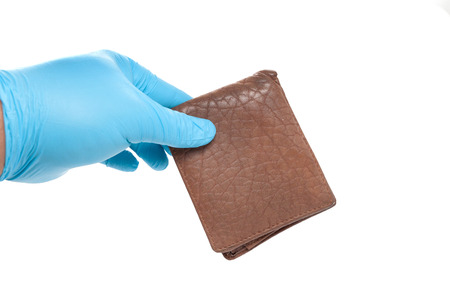 hand in blue glove holding a wallet