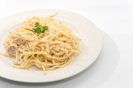 spaghetti carbonara with cream on white plateの写真素材