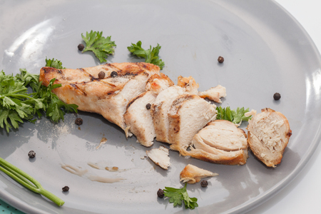 close up of grilled chicken breast on plateの写真素材