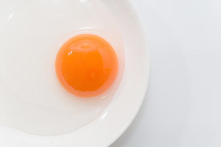 raw duck eggs in plate on white backgroundの写真素材