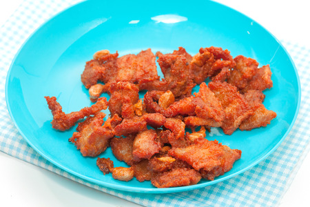 fired pork with garlic on blue plateの写真素材