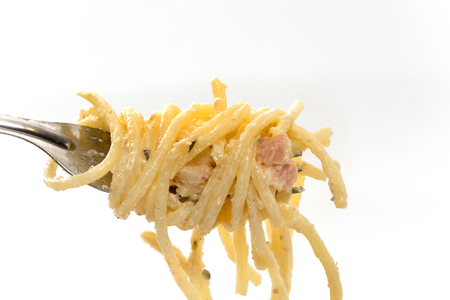 close up of spaghetti carbonara with cream and forkの写真素材