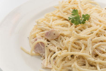 spaghetti carbonara with cream on white plateの写真素材