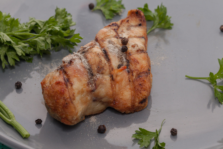 close up of grilled chicken breast on plateの写真素材