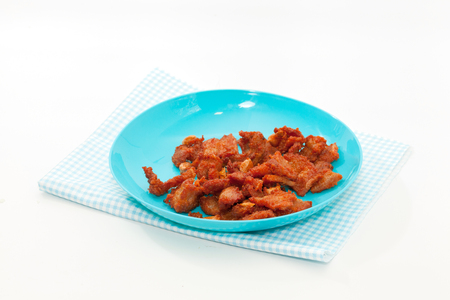 fired pork with garlic on blue plateの写真素材