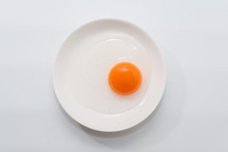 raw duck eggs in plate on white backgroundの写真素材