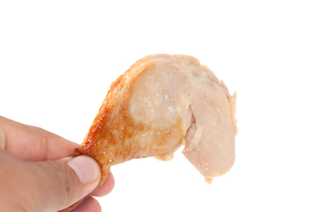 hand holding grilled Drumstick chicken isolated on white backgroundの写真素材